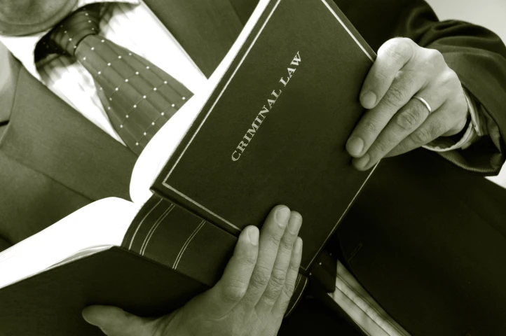 man-holding-criminal-book-1